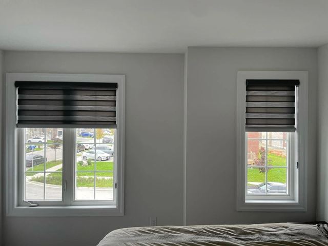 Dark layered shades in a bedroom