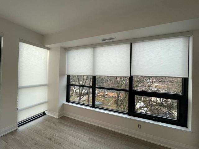 Light-filtering shades along a wall of windows