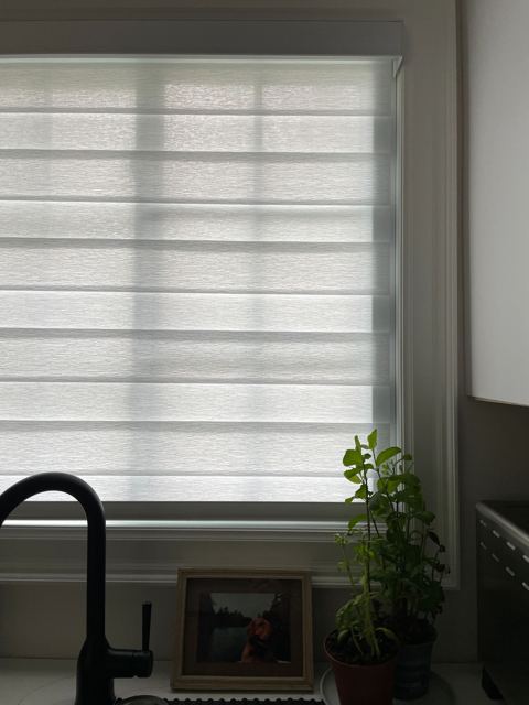 Layered shade above a kitchen sink