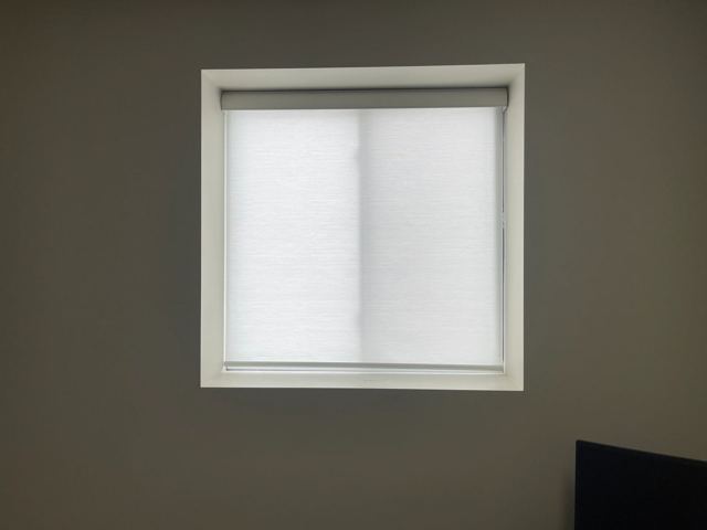 Light-filtering shade in a home office