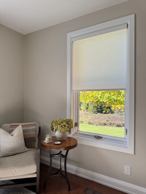 A roller shade in a bright sitting room