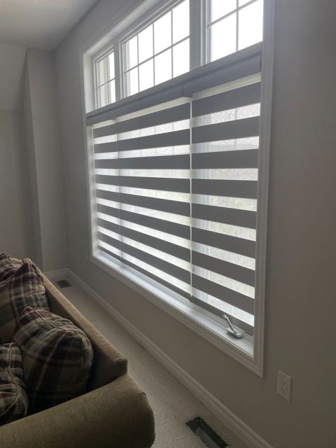 Layered shades on a tall living room window